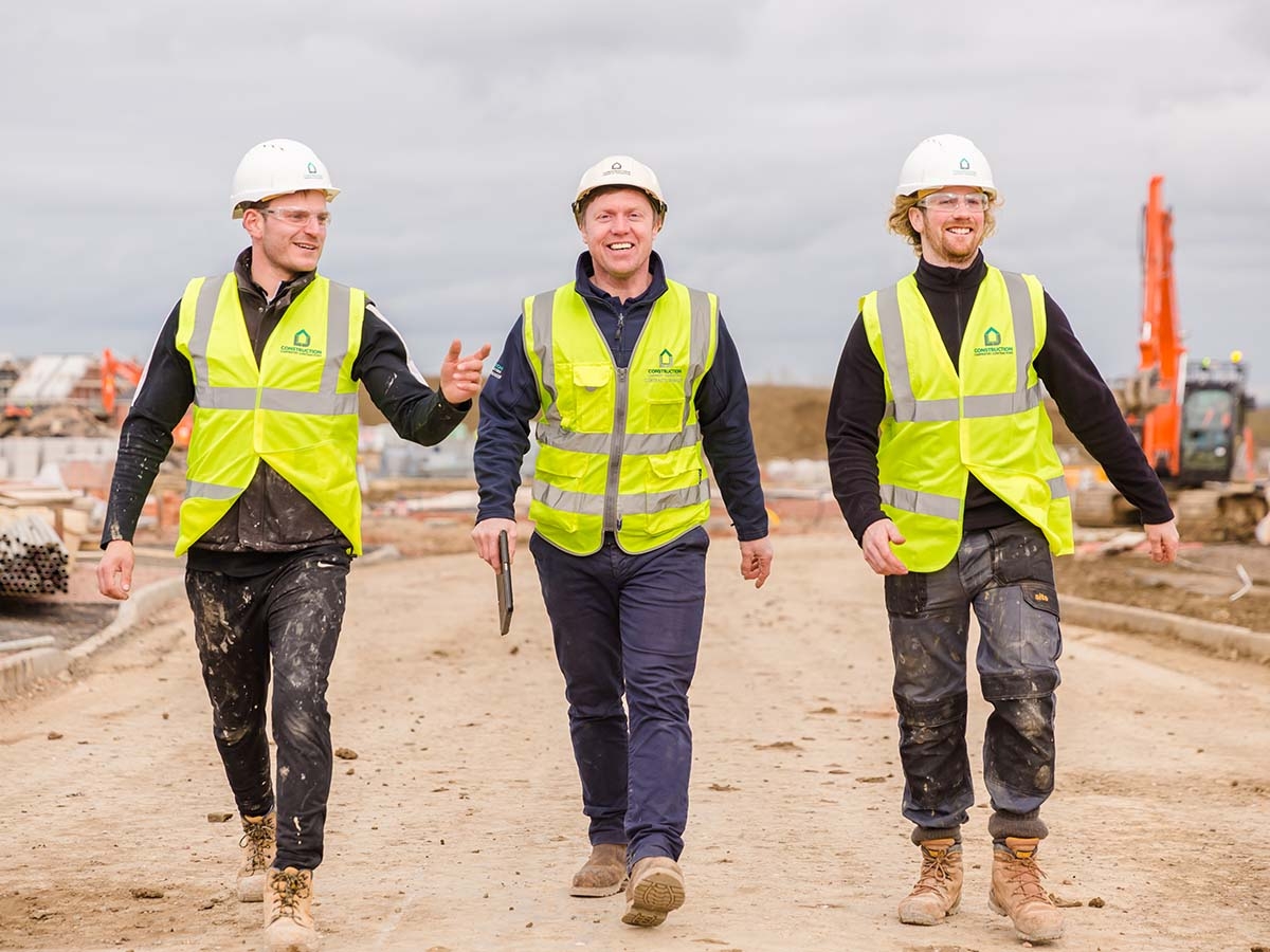 Carpentry contractors on site in LJ Construction branded PPE 