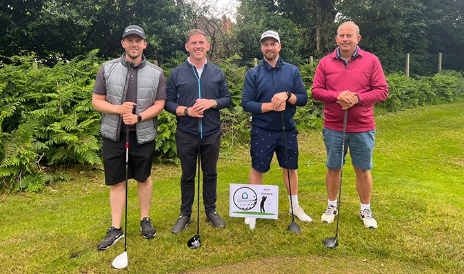 LJ Construction team ready to tee off with clubs ready in hands