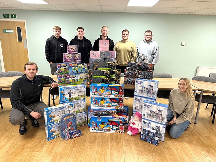 LJ Construction team gathered round piles of toys for christmas toy bank appeal