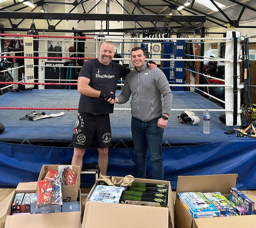 Ryan Jones director of LJ Construction shaking hands at South Moreton Boxing club after successful toy bank appeal