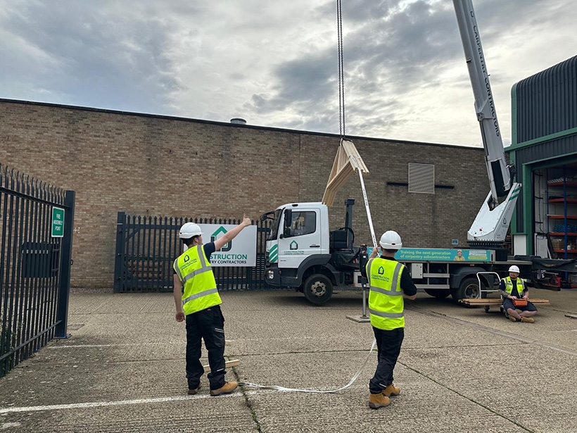 Two LJ Construction apprentices learning crane awareness and basic signalling]